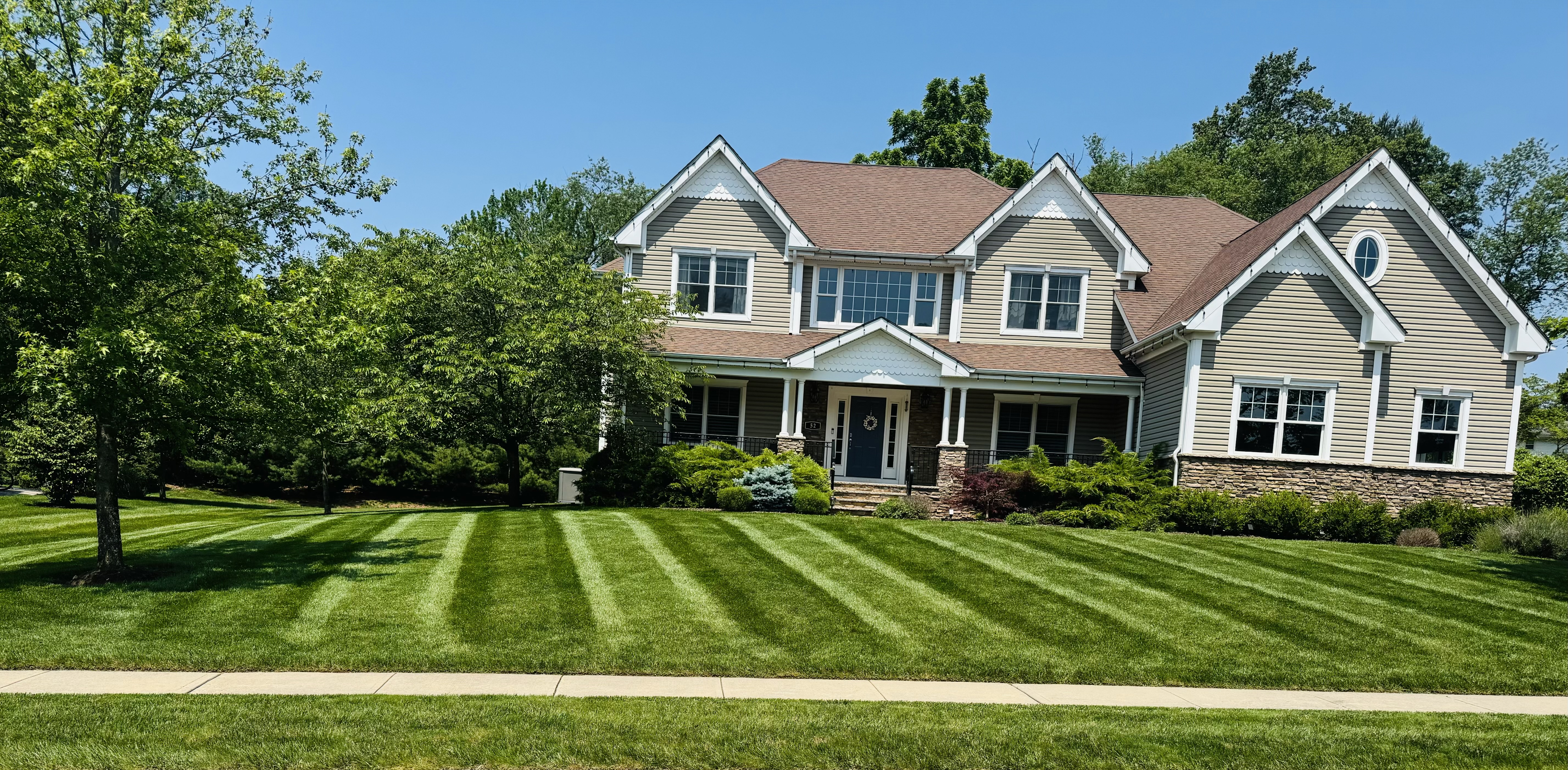 Healthy summer turf with fresh mowing stripes highlighting ideal grass height